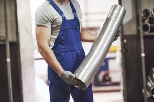 A portrait of handsome metal industry worker in factory
