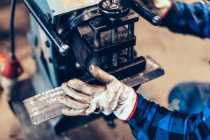 Manual steel plate bevelling process in a factory, workshop
