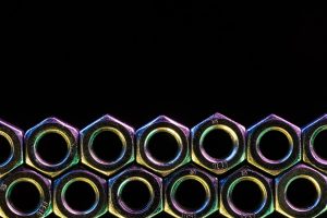 Seamless Shiny Steel Screws Pattern Isolated on Black