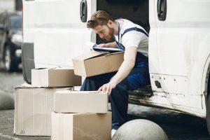 Delivery man with package outdoors